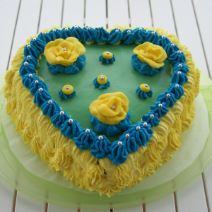Heart shape blue and yellow cream cake for birthday and anniversary delivery in Burdwan
